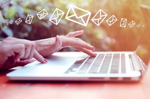 Woman-Sending-Email-Marketing-Messages-Laptop