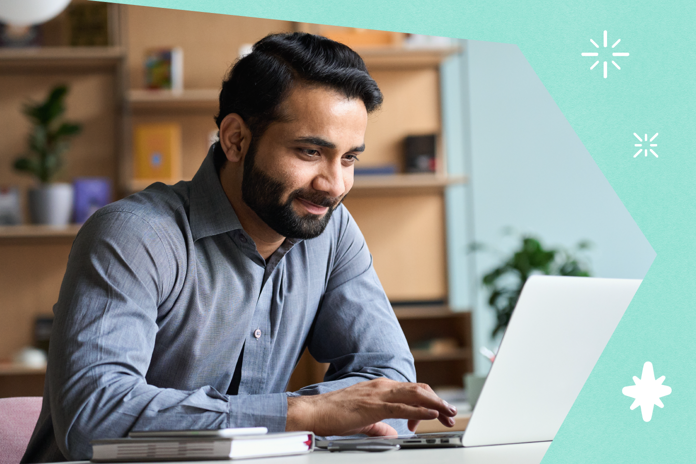 A man is seen researching CRMs on his laptop.